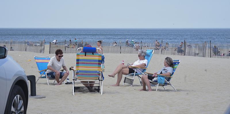 Executing the six-foot social distancing rule, a group enjoys the beach. DENY HOWETH PHOTO